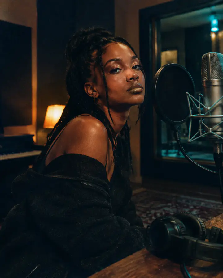 Recording artist in a studio beside a microphone