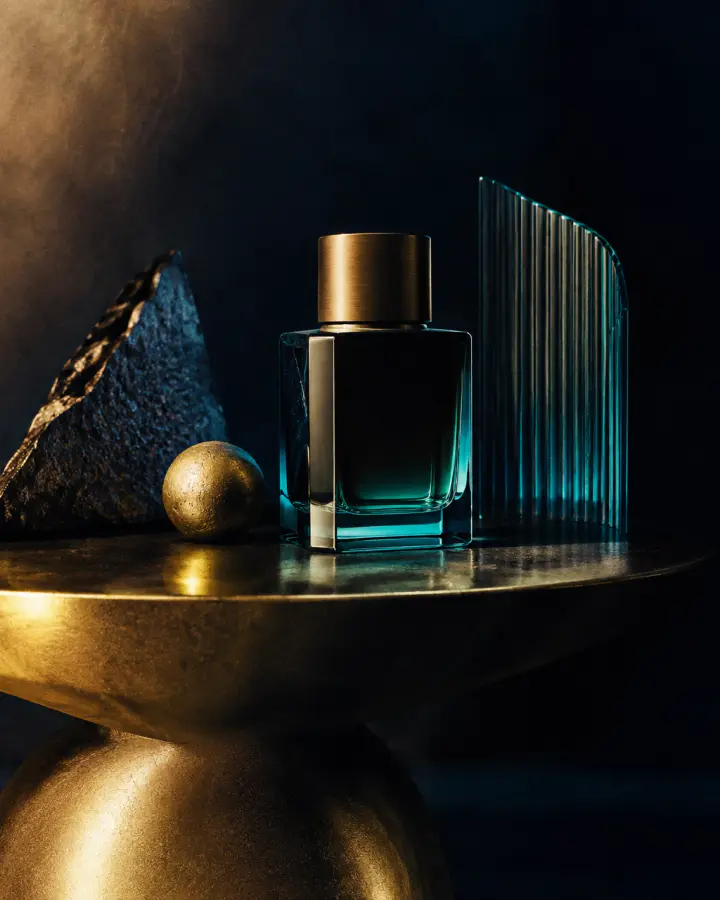 Sculptural product still life with warm gold and teal light